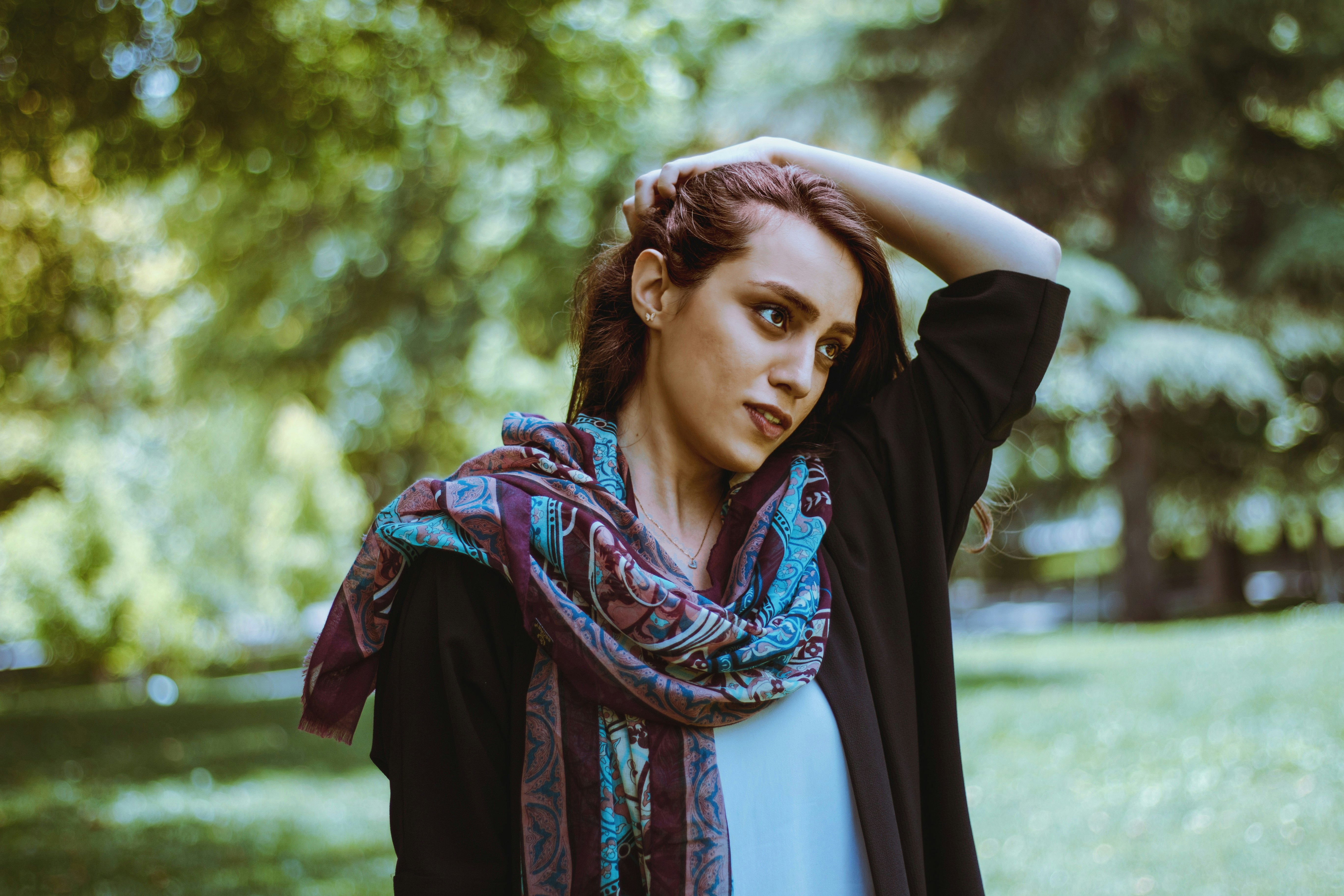 woman holding her hair during daytime